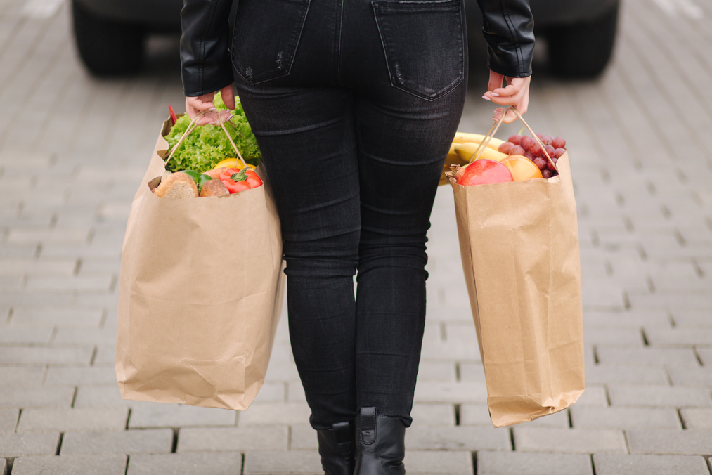 Woman Loading Groceries from the Supermarket to Car Trunk
